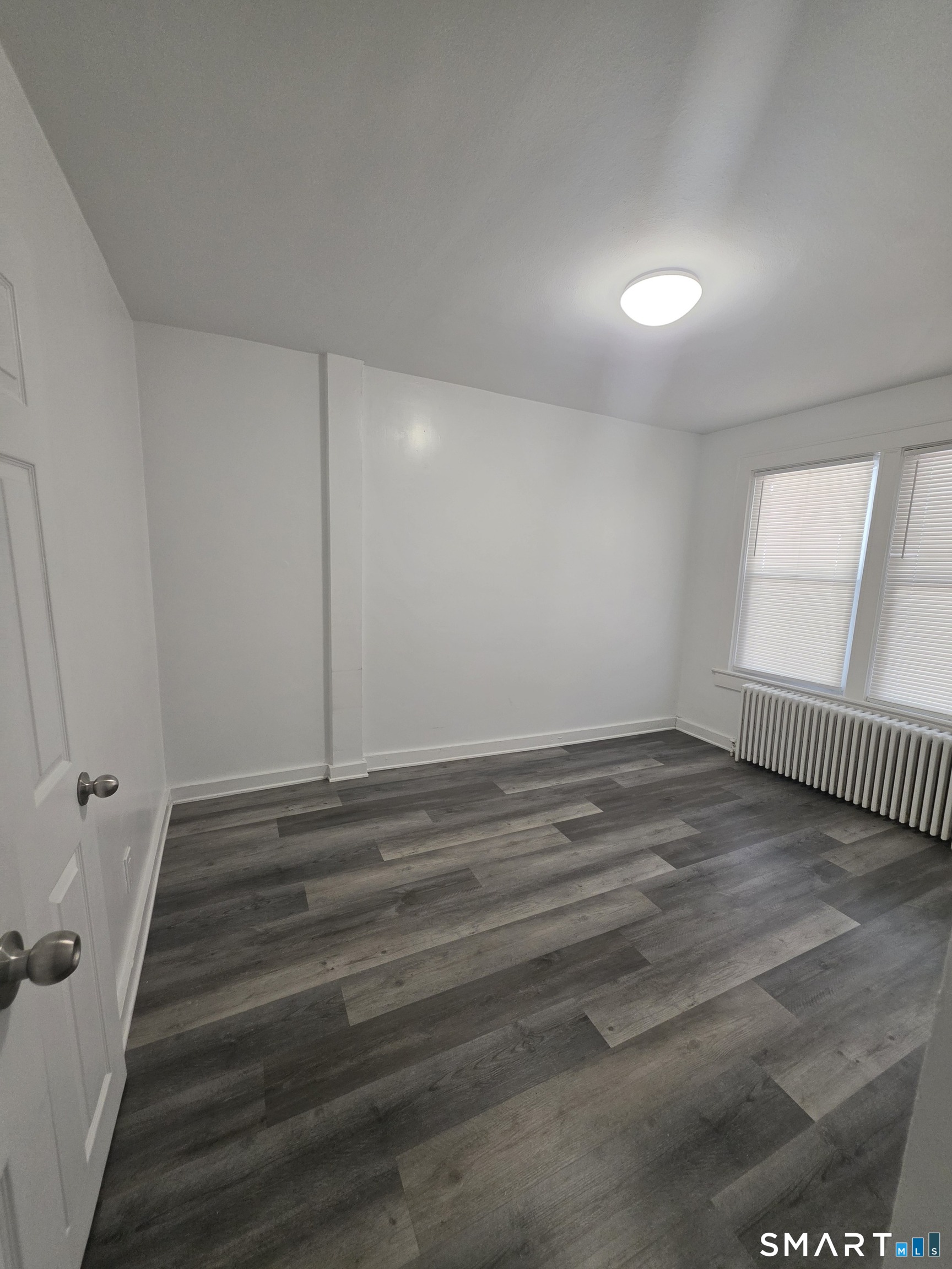 8 Mannz Street Hartford, CT 06114 - Photo 20 of 22 a view of a room with wooden floor and window