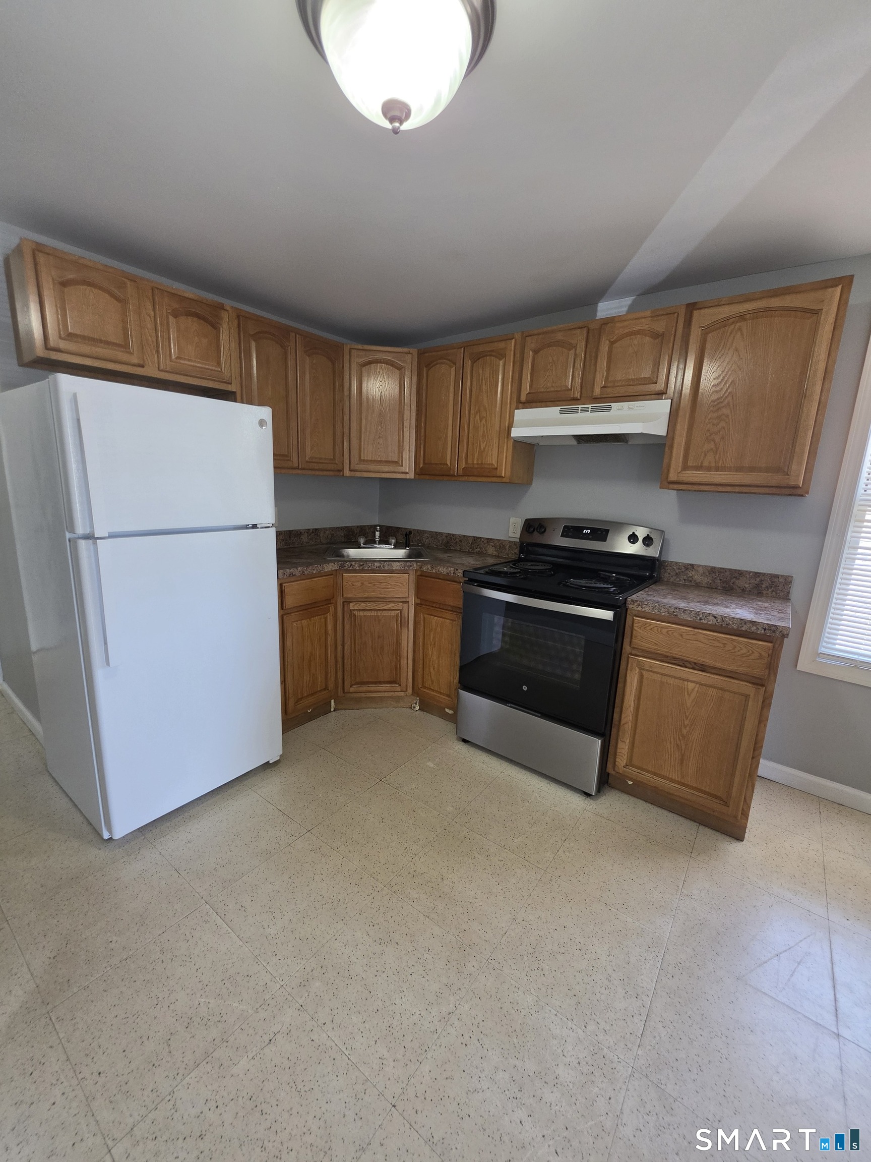 8 Mannz Street Hartford, CT 06114 - Photo 2 of 22 a kitchen with stainless steel appliances granite countertop a stove a sink and a refrigerator