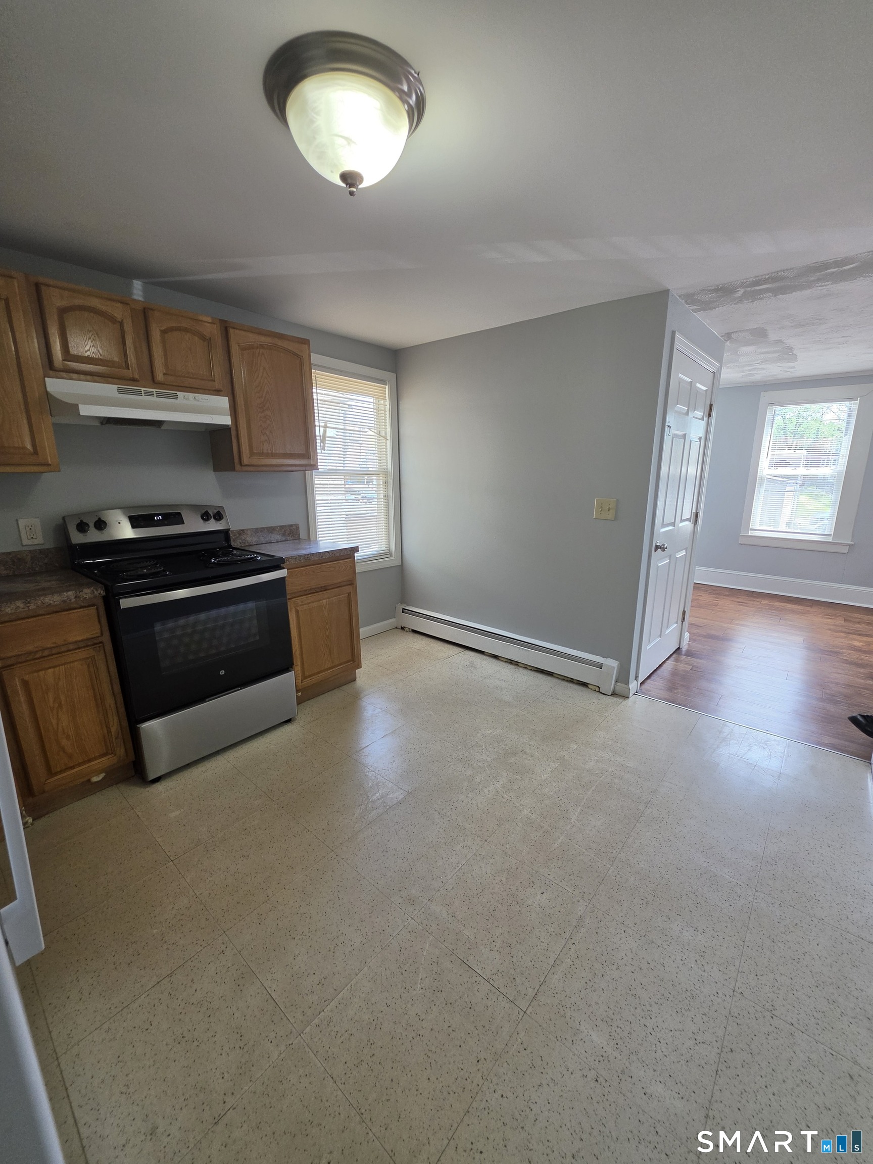 8 Mannz Street Hartford, CT 06114 - Photo 3 of 22 a kitchen with stainless steel appliances granite countertop a stove and a refrigerator