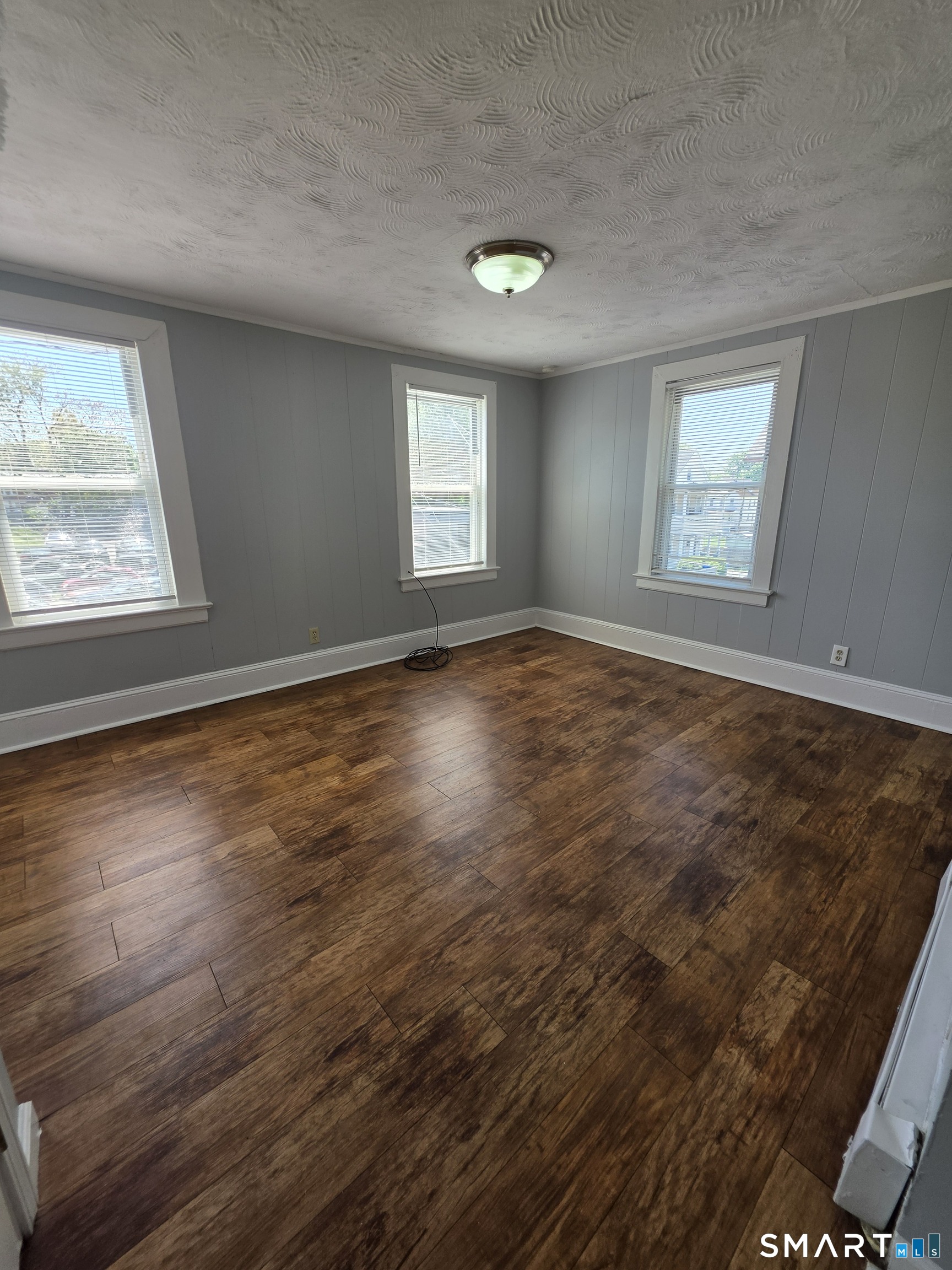 8 Mannz Street Hartford, CT 06114 - Photo 5 of 22 an empty room with wooden floor and windows