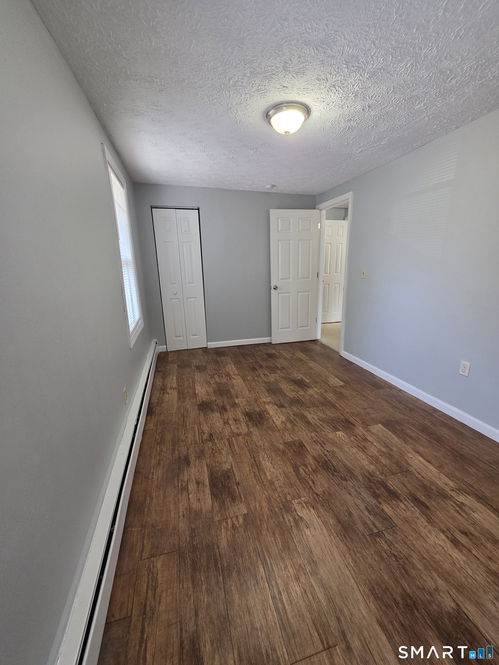 8 Mannz Street Hartford, CT 06114 - Photo 8 of 22 a view of empty room with wooden floor
