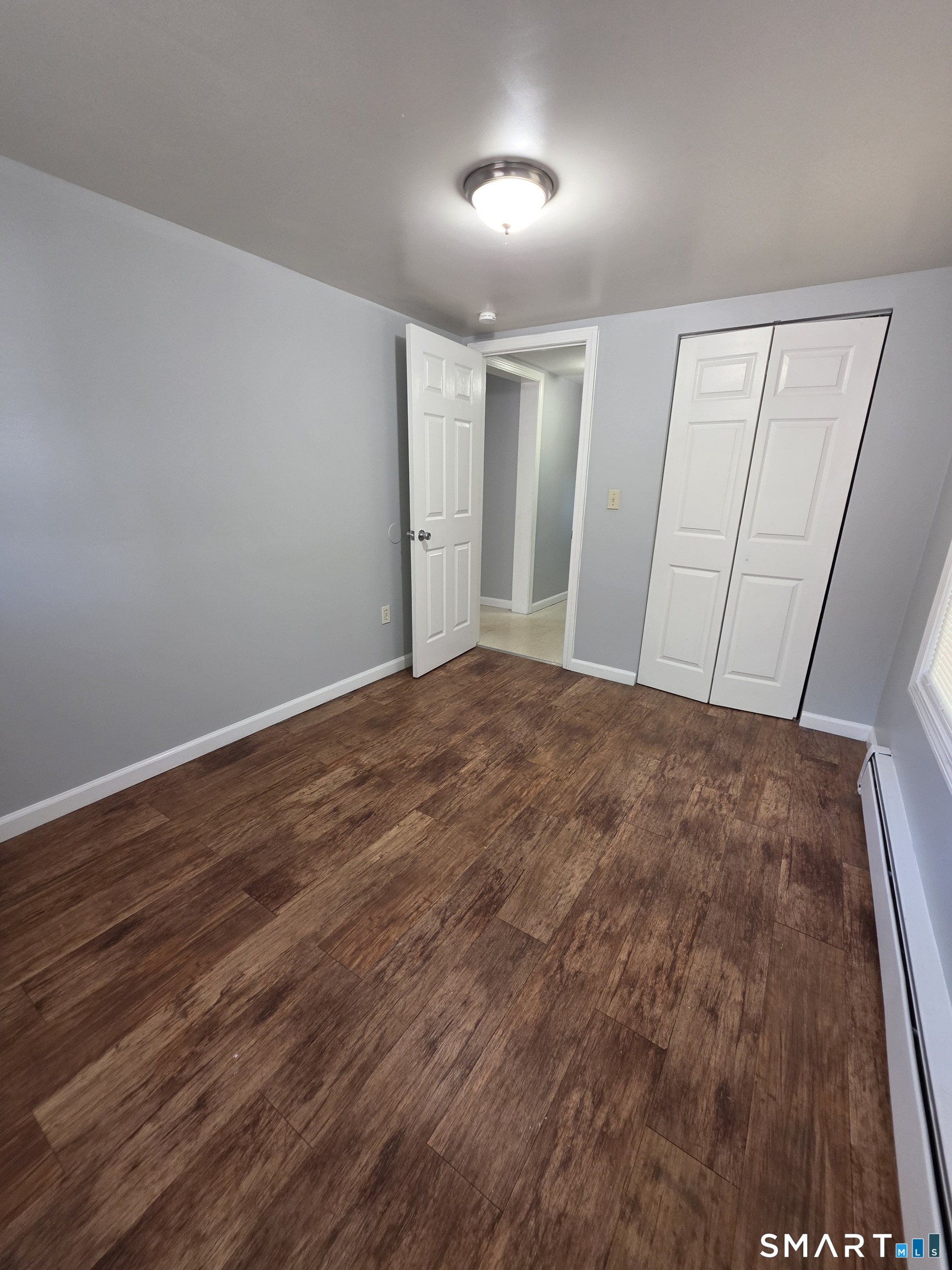 8 Mannz Street Hartford, CT 06114 - Photo 10 of 22 wooden floor in an empty room with a window