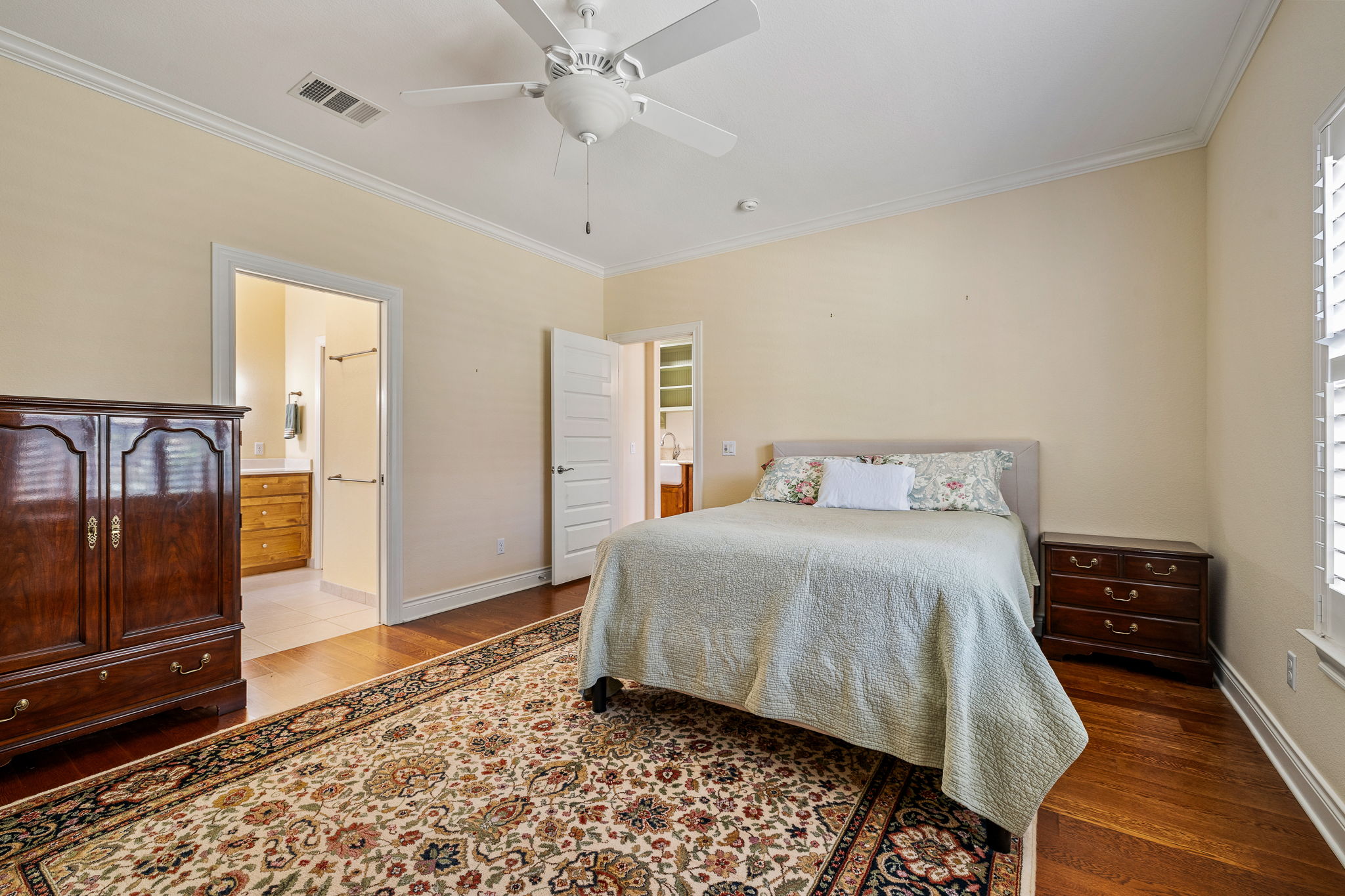 5201 Big Spring Street Georgetown, TX 78633 - Photo 14 of 26 Bedroom featuring crown molding, light wood finished floors, a ceiling fan, and connected bathroom