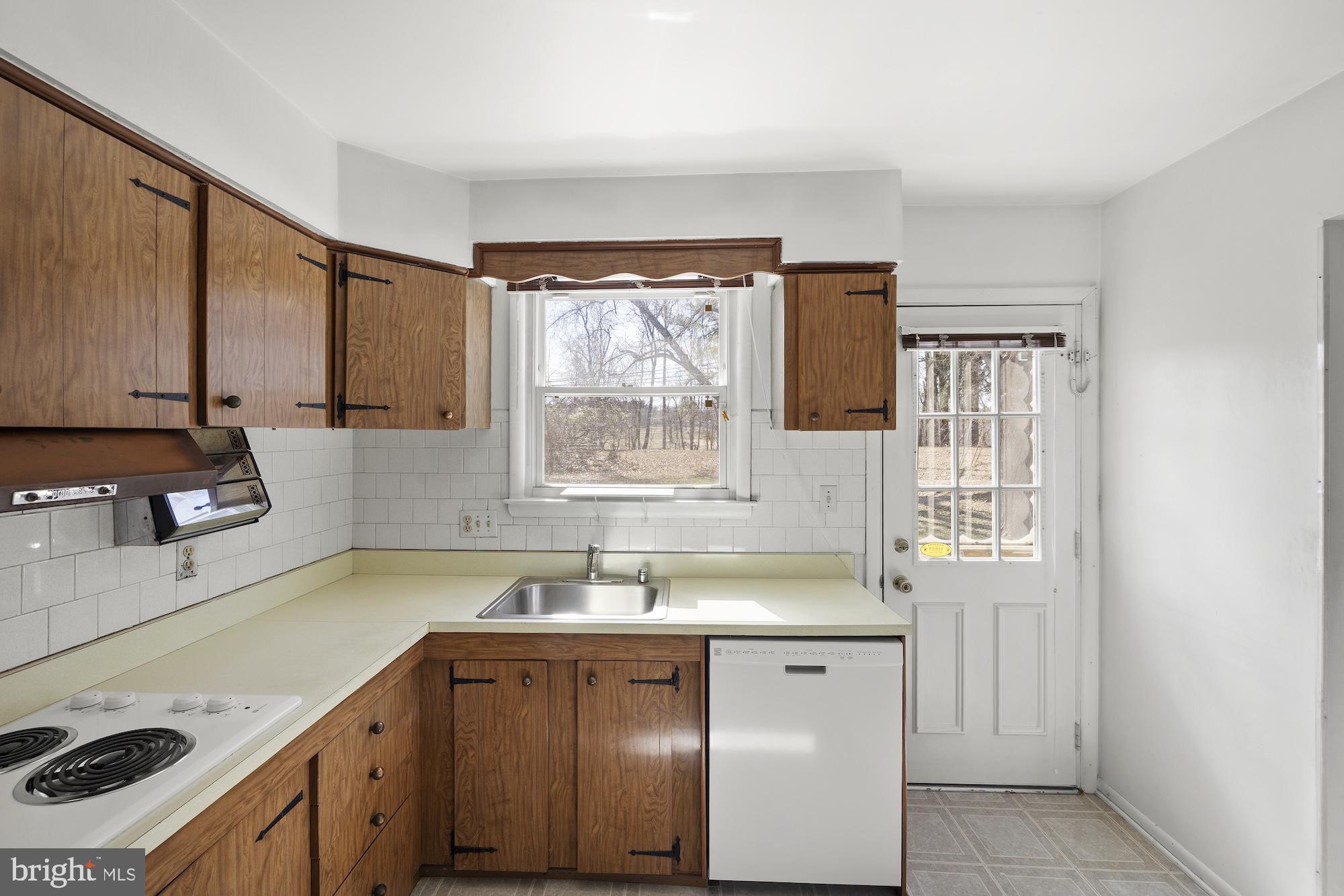 8605 Lucerne Road Randallstown, MD 21133 - Photo 13 of 30 a kitchen with a sink stove and cabinets