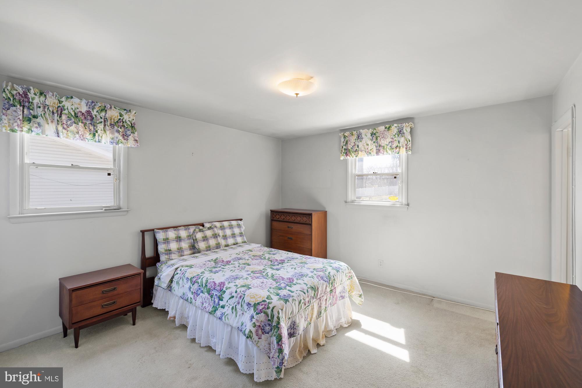 8605 Lucerne Road Randallstown, MD 21133 - Photo 16 of 30 a bedroom with a bed and a chair