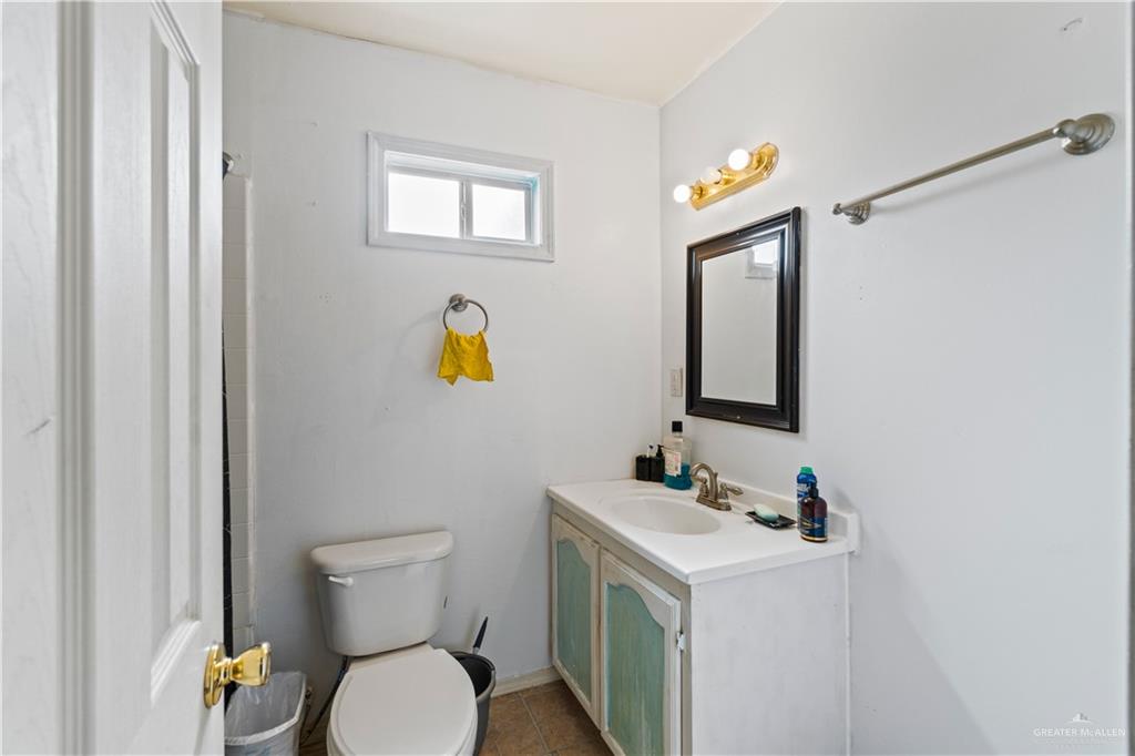 106 Rosa Priego Street Donna, TX 78537 - Photo 14 of 25 Bathroom featuring tile patterned floors, vanity, and toilet