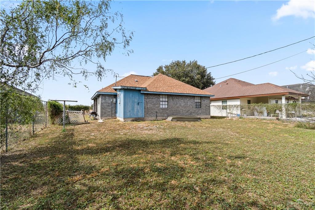 106 Rosa Priego Street Donna, TX 78537 - Photo 21 of 25 Rear view of house with a lawn