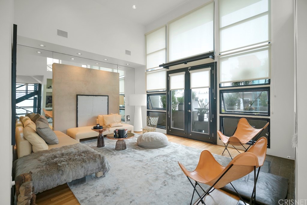 a living room with furniture and a floor to ceiling window
