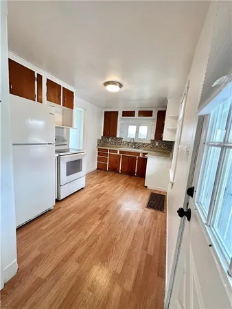 a view of washer and dryer with wooden floor