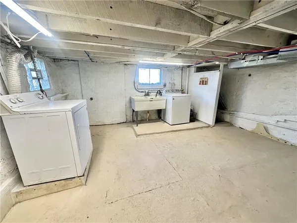 a view of storage and utility room with a refrigerator