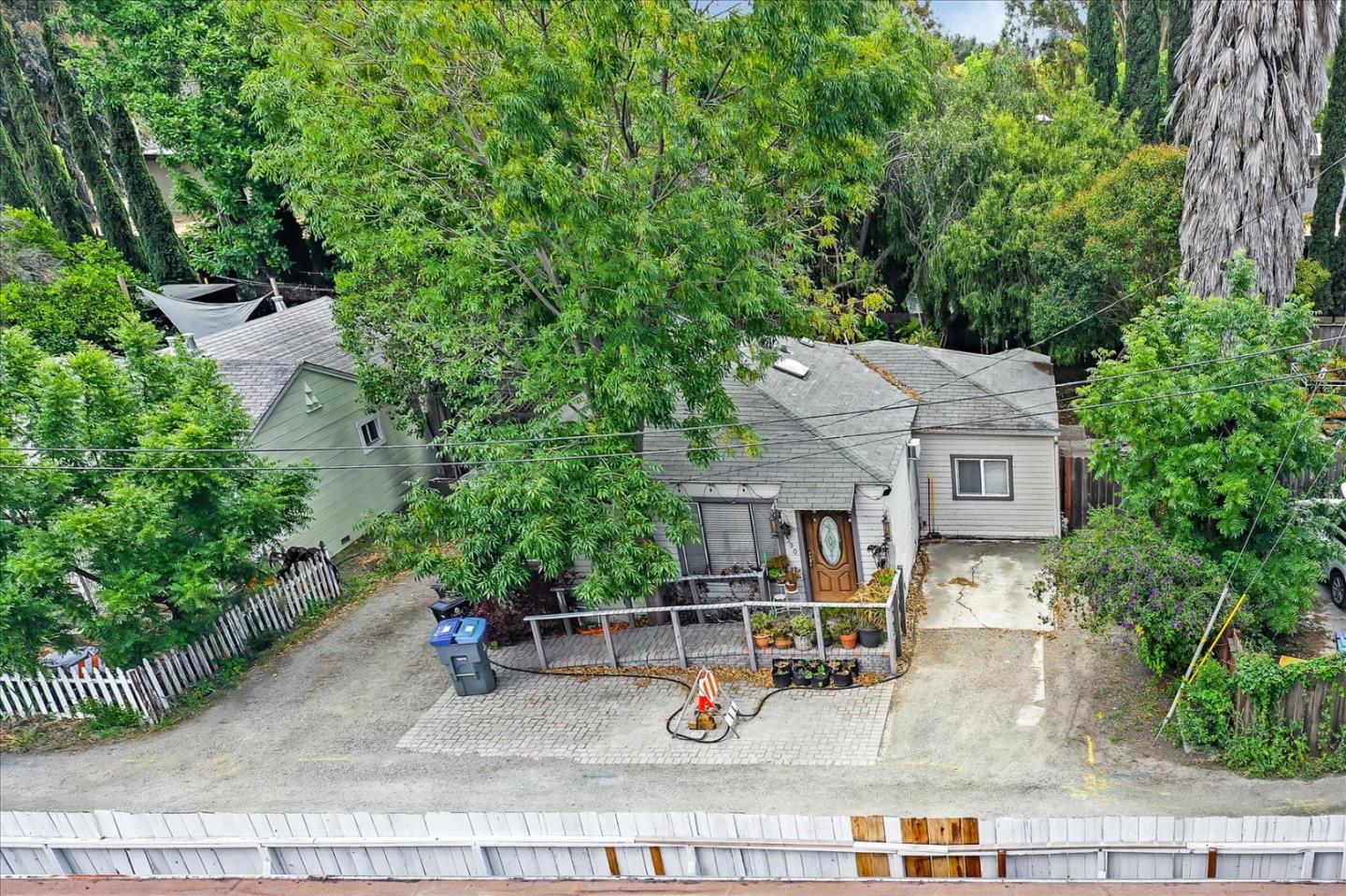 an aerial view of a house with outdoor seating