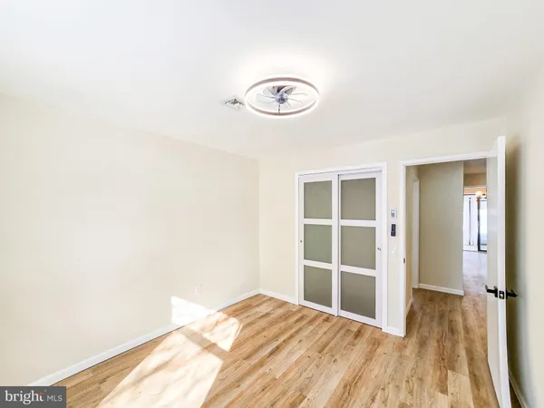 a view of a room with wooden floor and bathroom