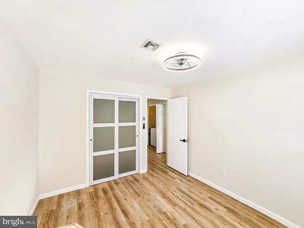 a view of a room with wooden floor and window