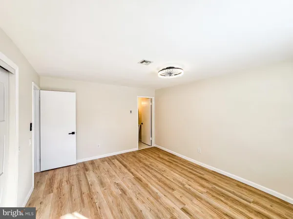 a view of a room with wooden floor