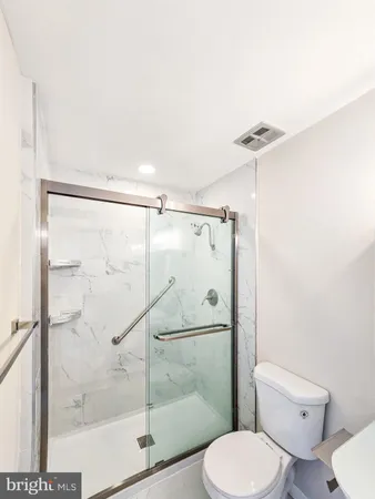 a bathroom with a toilet and a shower