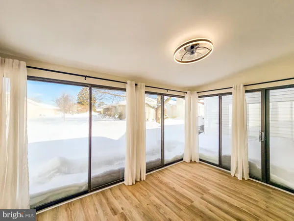 a view of a room with wooden floor and windows
