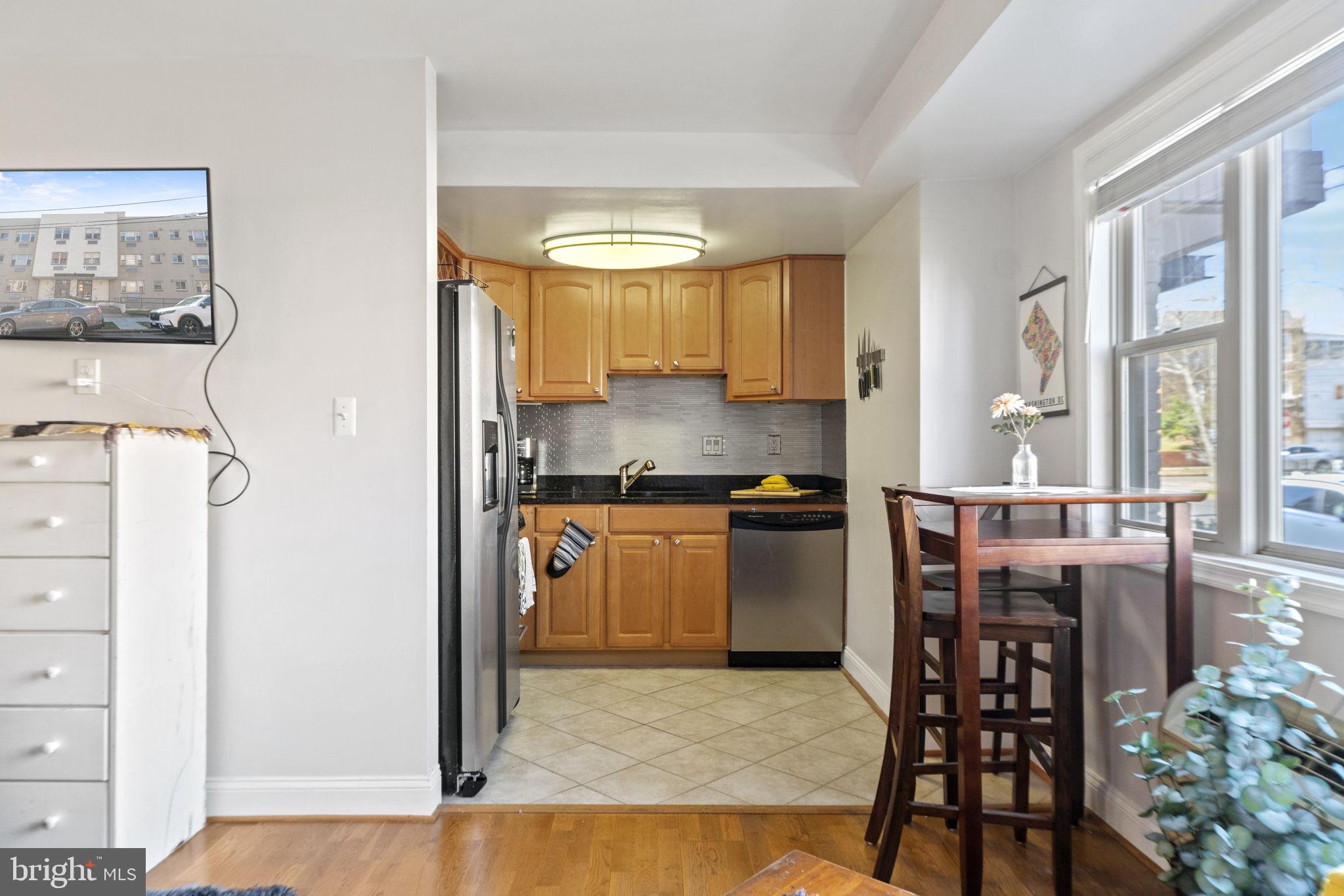 738 Longfellow Street Northwest, Unit 209 Washington, DC 20011 - Photo 6 of 21 Wood floors and ceramic tile