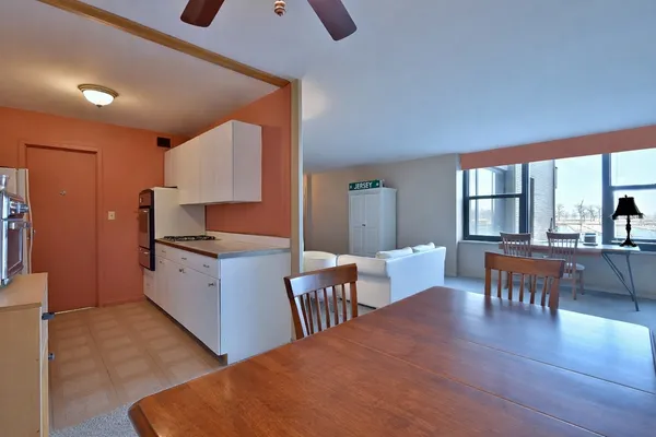 a large kitchen with a table and chairs in it