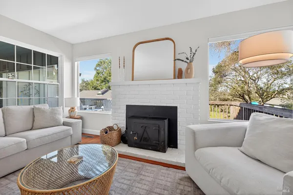 a living room with furniture a window and a fireplace