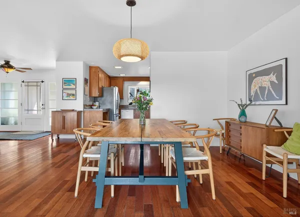 a view of a dining room with furniture wooden floor and chandelier