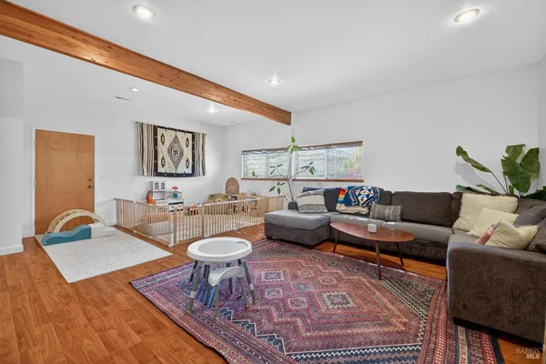 a living room with furniture a rug and a lamp