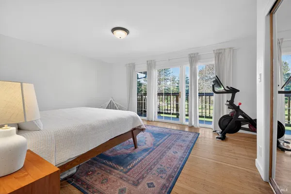 a bed room with a bed and a large window