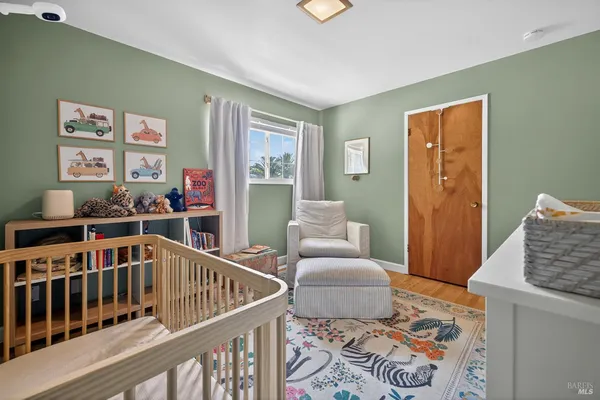a bedroom with furniture and wooden floor