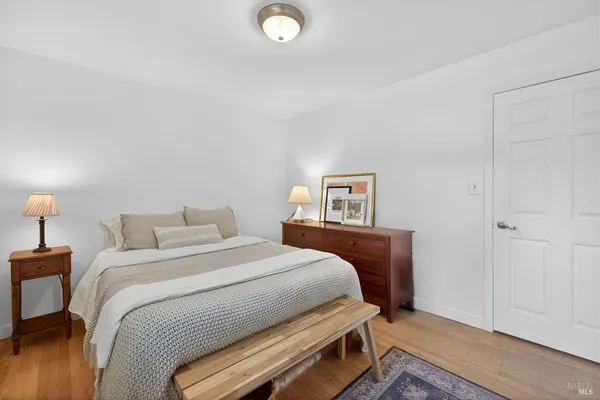 a bedroom with a bed and a lamp on table