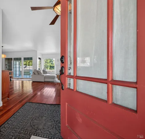 a view of an entryway with wooden floor