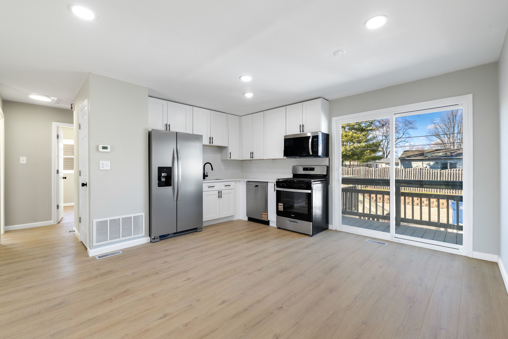 222 Pell Avenue Romeoville, IL 60446 - Photo 7 of 27 a kitchen with stainless steel appliances a refrigerator and a stove top oven