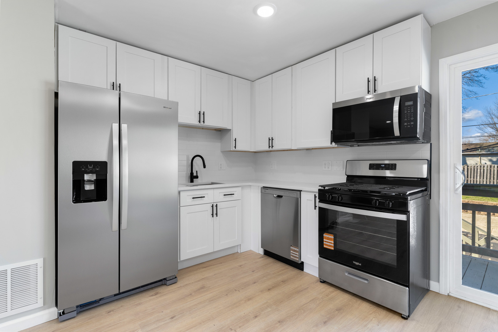 222 Pell Avenue Romeoville, IL 60446 - Photo 8 of 27 a kitchen with stainless steel appliances granite countertop a stove a refrigerator and a microwave