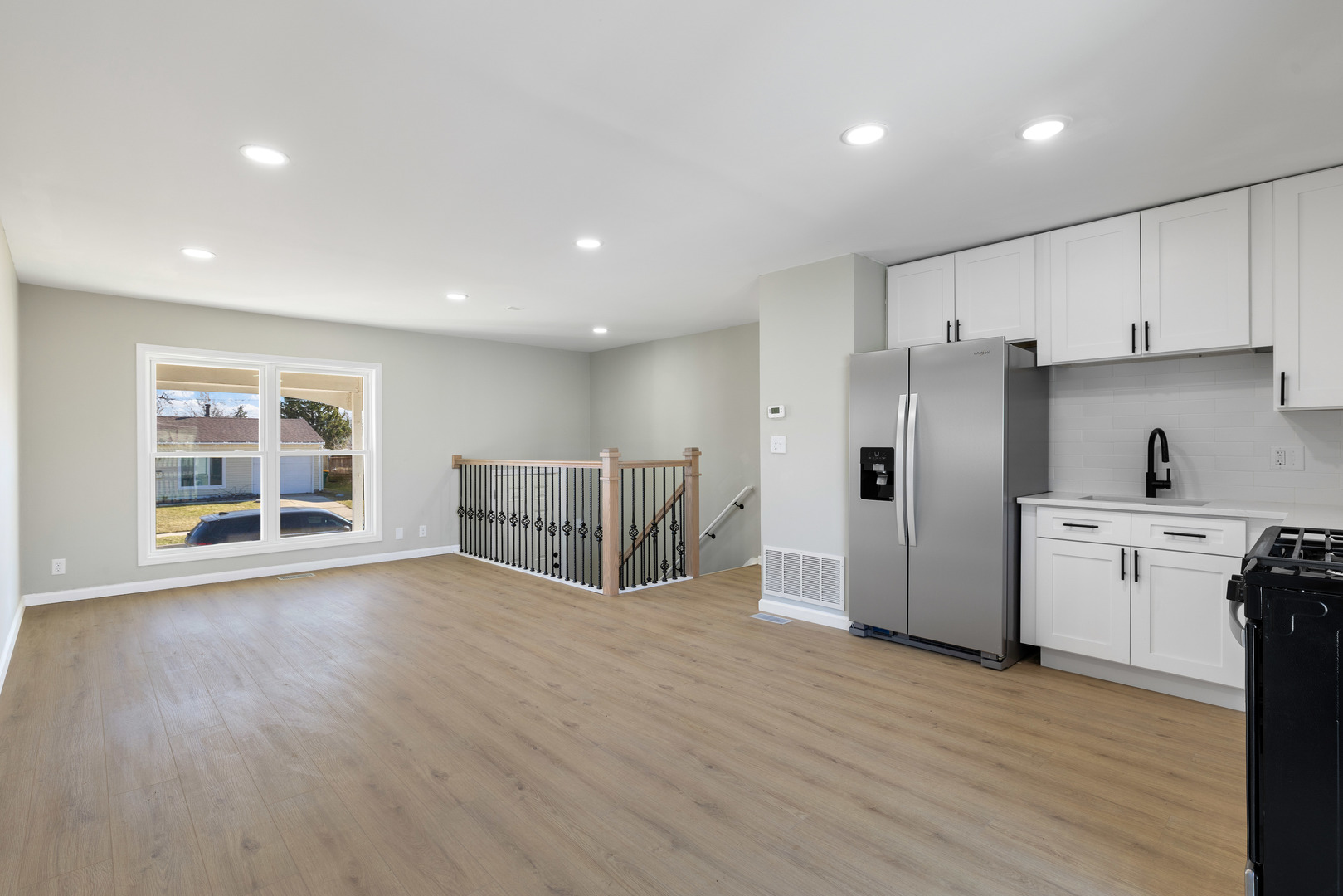 222 Pell Avenue Romeoville, IL 60446 - Photo 9 of 27 a view of a kitchen with a sink and dishwasher a refrigerator with wooden floor
