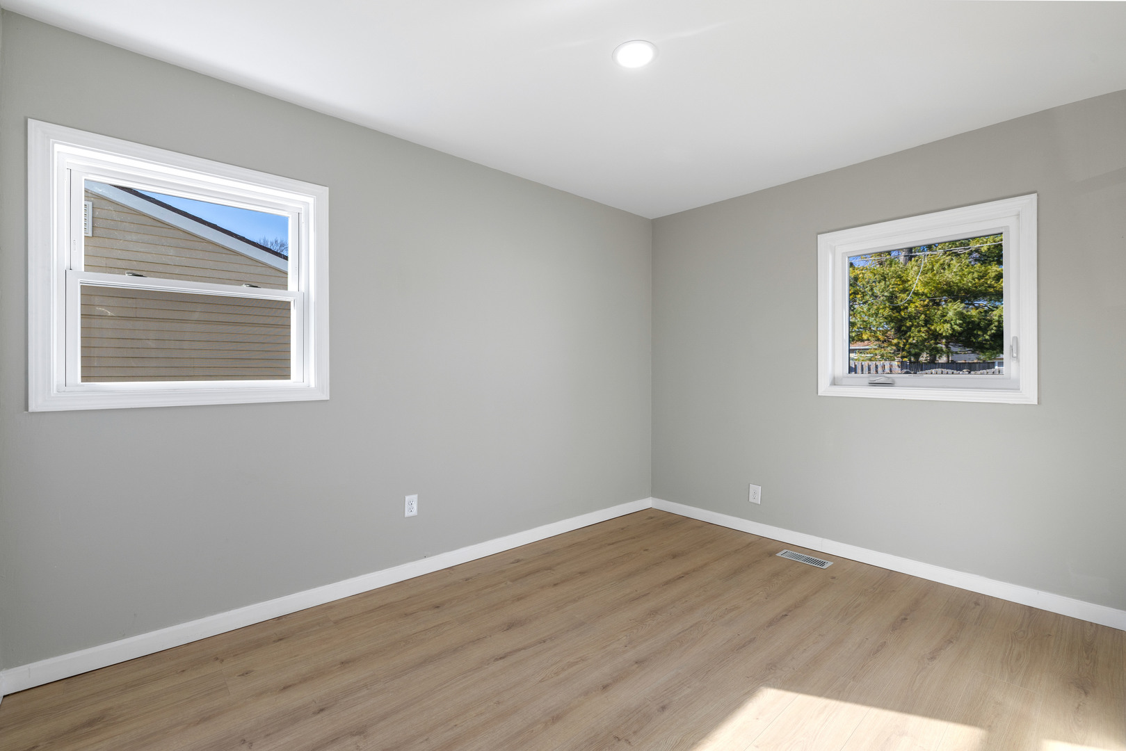 222 Pell Avenue Romeoville, IL 60446 - Photo 10 of 27 a view of an empty room with wooden floor and a window