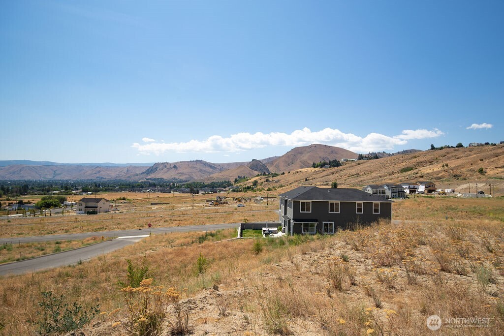 0 Lot 4 Farmstead Lane Wenatchee, WA 98801 - Photo 14 of 24 a view of a house with a mountain