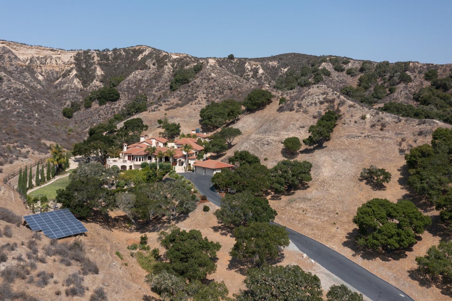 a view of a forest with mountains in the background