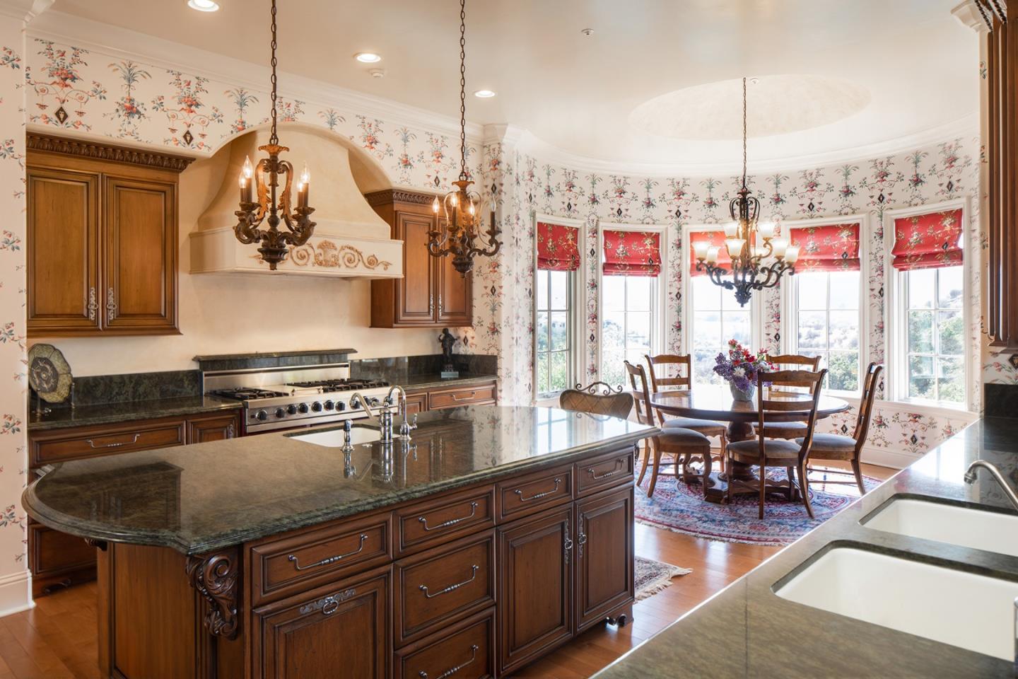14501 Roland Canyon Road Salinas, CA 93908 - Photo 15 of 53 a kitchen with a table chairs stove and cabinets