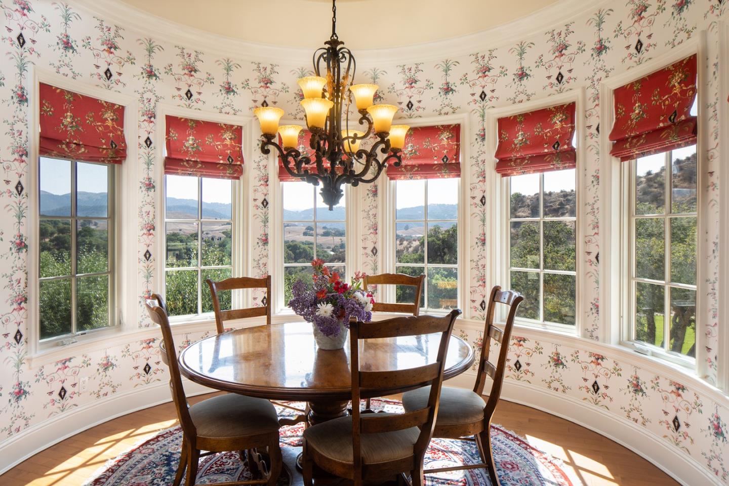 14501 Roland Canyon Road Salinas, CA 93908 - Photo 18 of 53 a view of a dining room with furniture large windows and wooden floor