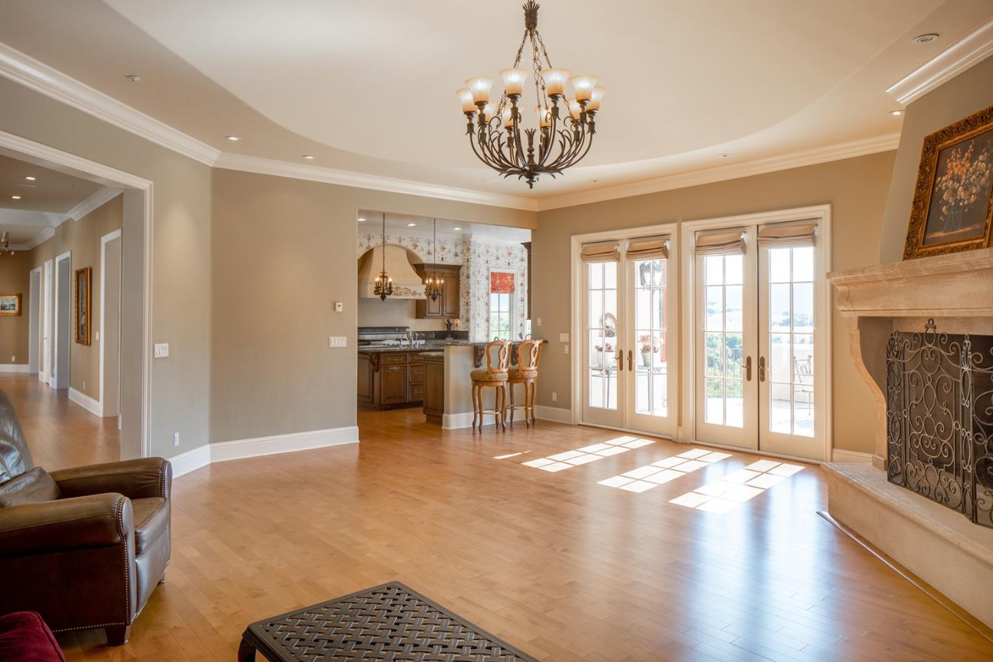 14501 Roland Canyon Road Salinas, CA 93908 - Photo 21 of 53 a view of a livingroom with a chandelier wooden floor a chandelier and windows