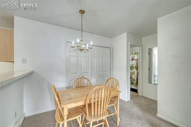 a view of a dining room with furniture and chandelier