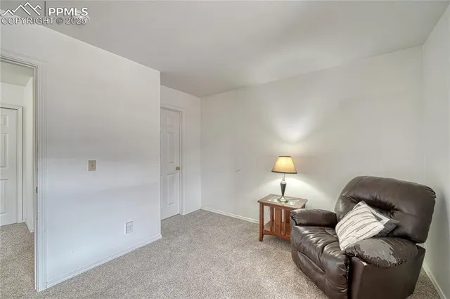 a living room with furniture and a lamp
