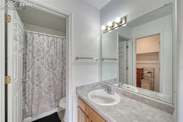 a bathroom with a granite countertop sink a mirror and a shower