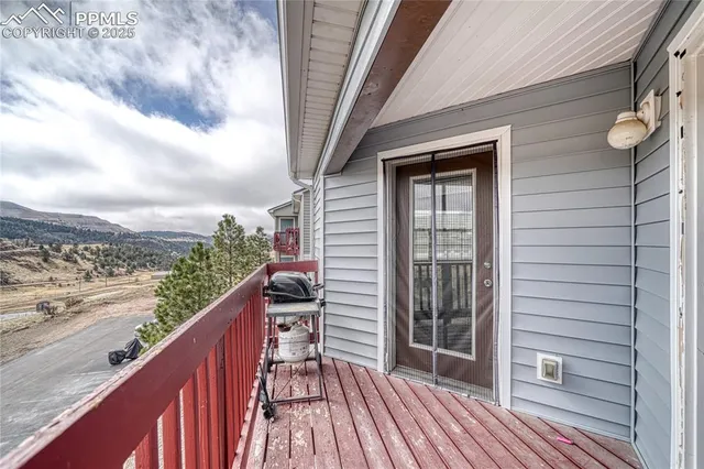 a view of balcony with wooden floor and fence