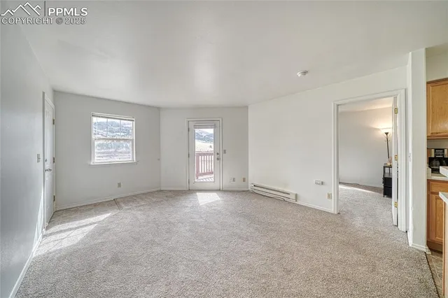 an empty room with windows and closet