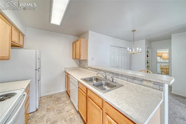 a kitchen with a sink stove and refrigerator