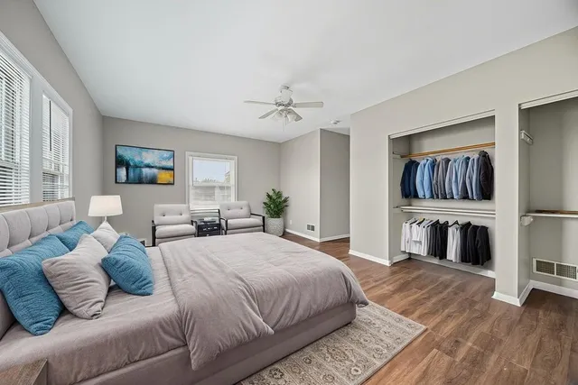 a spacious bedroom with a bed and ceiling fan