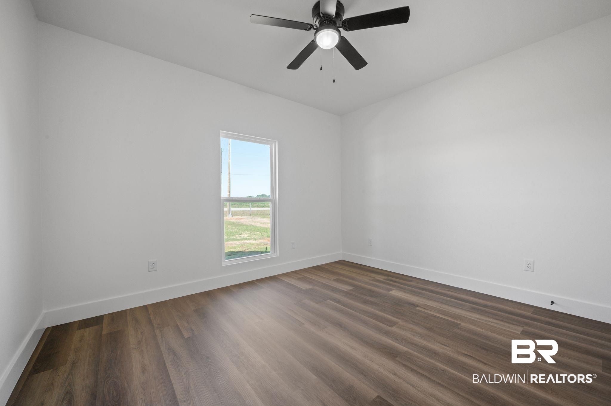12100 Lott Road Chunchula, AL 36521 - Photo 14 of 21 Empty room featuring hardwood / wood-style floors and ceiling fan