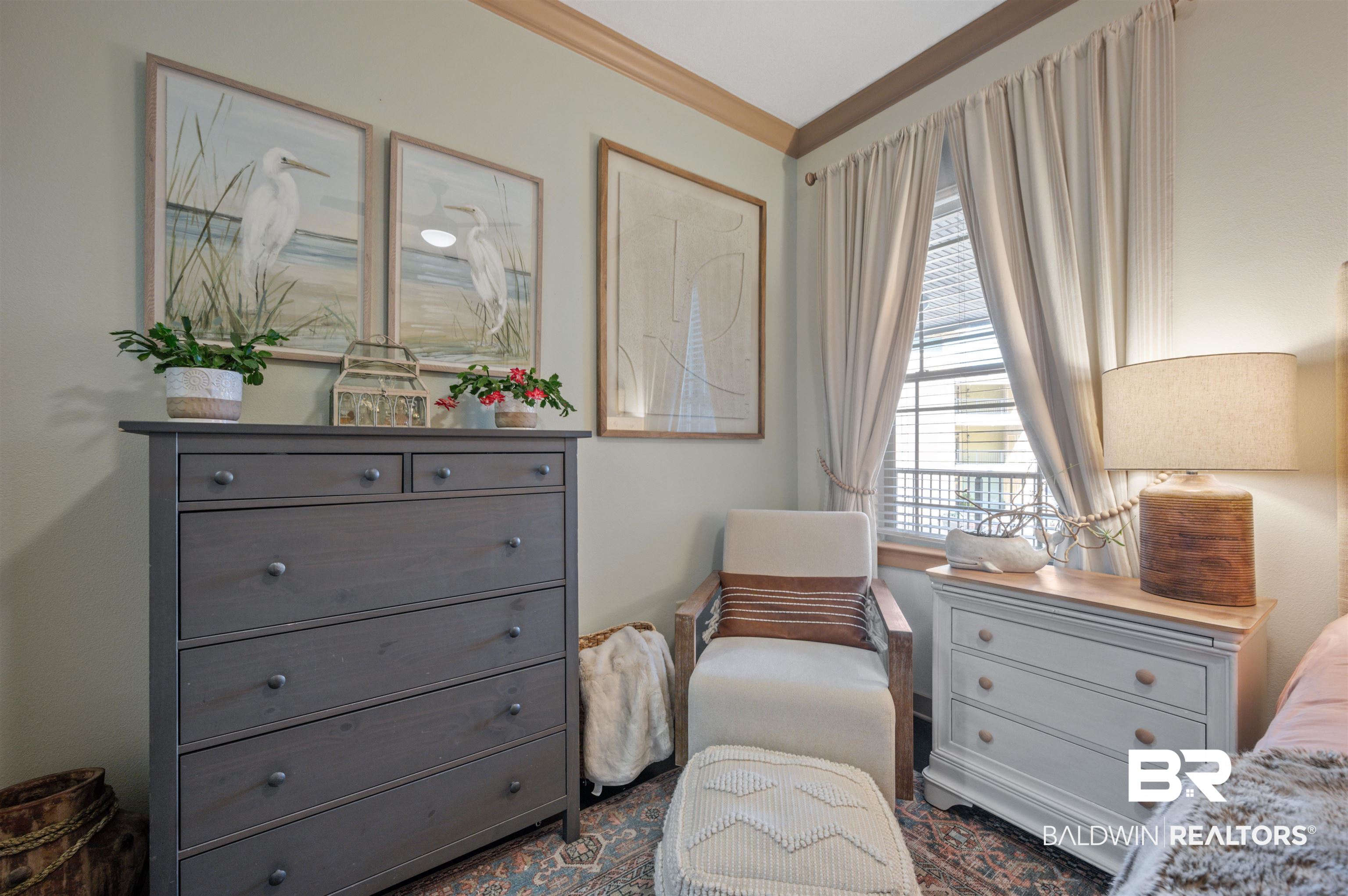 1430 Regency Road, Unit B202 Gulf Shores, AL 36542 - Photo 12 of 33 Living area featuring crown molding and a healthy amount of sunlight