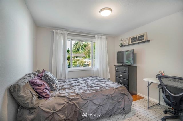 a bedroom with a bed and a television