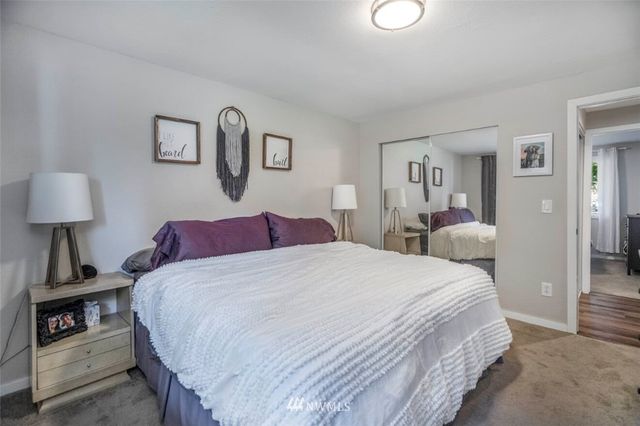 a bedroom with a bed and a lamp