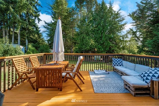 a view of a chair and table on the deck